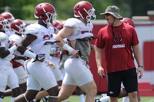Ben Herbert, Arkansas head strength and conditioning coach, directs players in a warm-up period prior to practice Saturday, Aug. 6, 2016, at the football practice field on the university campus in Fayetteville. 