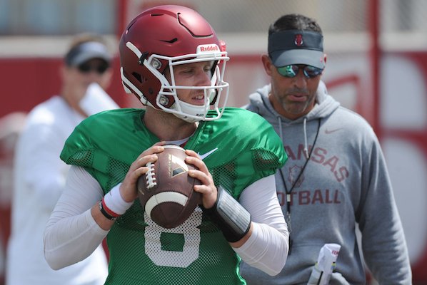 Arkansas quarterback Austin Allen participates in a drill as Dan Enos, Arkansas offensive coordinator and quarterbacks coach, looks on during practice Saturday, Aug. 6, 2016, at the football practice field on the university campus in Fayetteville. Visit nwadg.com/photos to see more photographs from the day's practice.