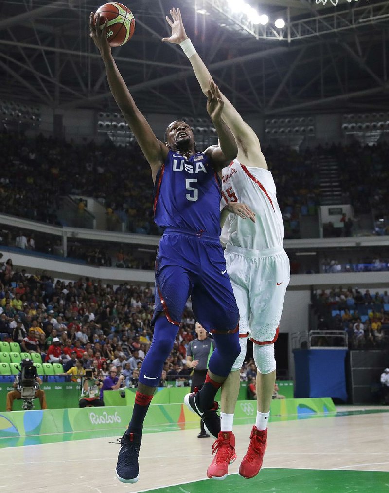 United States forward Kevin Durant (5) scores in front of China’s Zhou Qi (15) during Saturday’s Group A game in Rio de Janeiro. Durant, who plays for the NBA’s Golden State Warriors, scored 25 points to lead the Americans to a 119-62 victory.