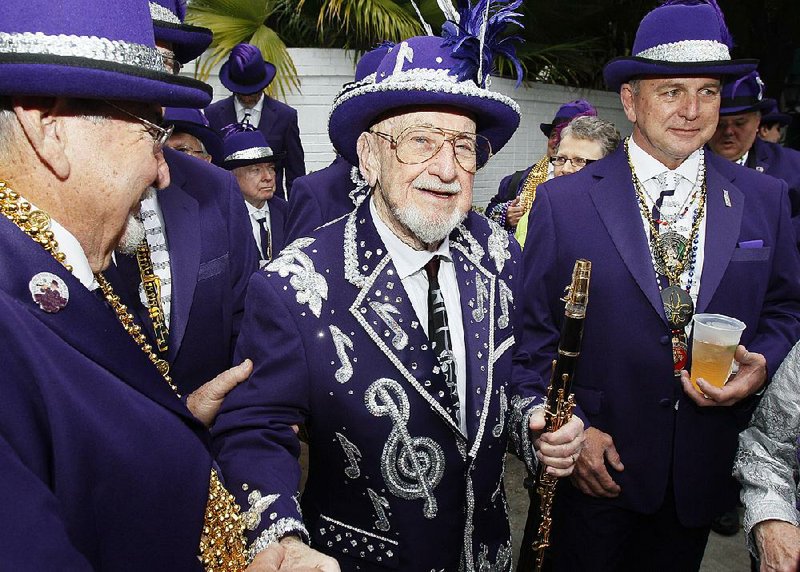 Musician Pete Fountain, center, greets friends as he prepares to lead his Half-Fast Walking Club through downtown and into the French Quarter in New Orleans on Mardi Gras Day, Tuesday, March 8, 2011. 