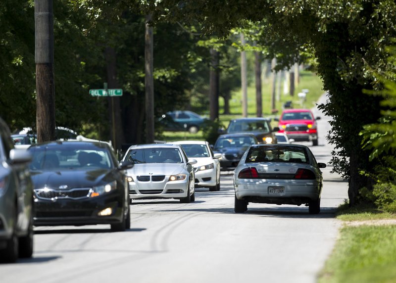 Traffic moves along SE 8th Street on Friday just west of Moberly Lane in Bentonville.