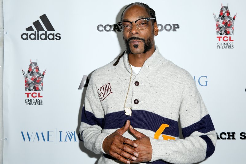 FILE- In this May 16, 2016, file photo, Snoop Dogg arrives at the LA Premiere of &quot;Coach Snoop&quot; at the TCL Chinese 6 Theatres in Los Angeles. Authorities say multiple people have been hurt after a railing collapsed during an outdoor concert by Snoop Dogg and Wiz Khalifa in southern New Jersey on Friday, Aug. 5. (Photo by Rich Fury/Invision/AP, File)