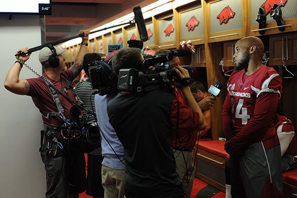 Arkansas senior running back Kody Walker answers questions from members of the news media Sunday, Aug. 7, 2016, during the team's annual Media Day activities in the Fred W. Smith Football Center on the university campus in Fayetteville.