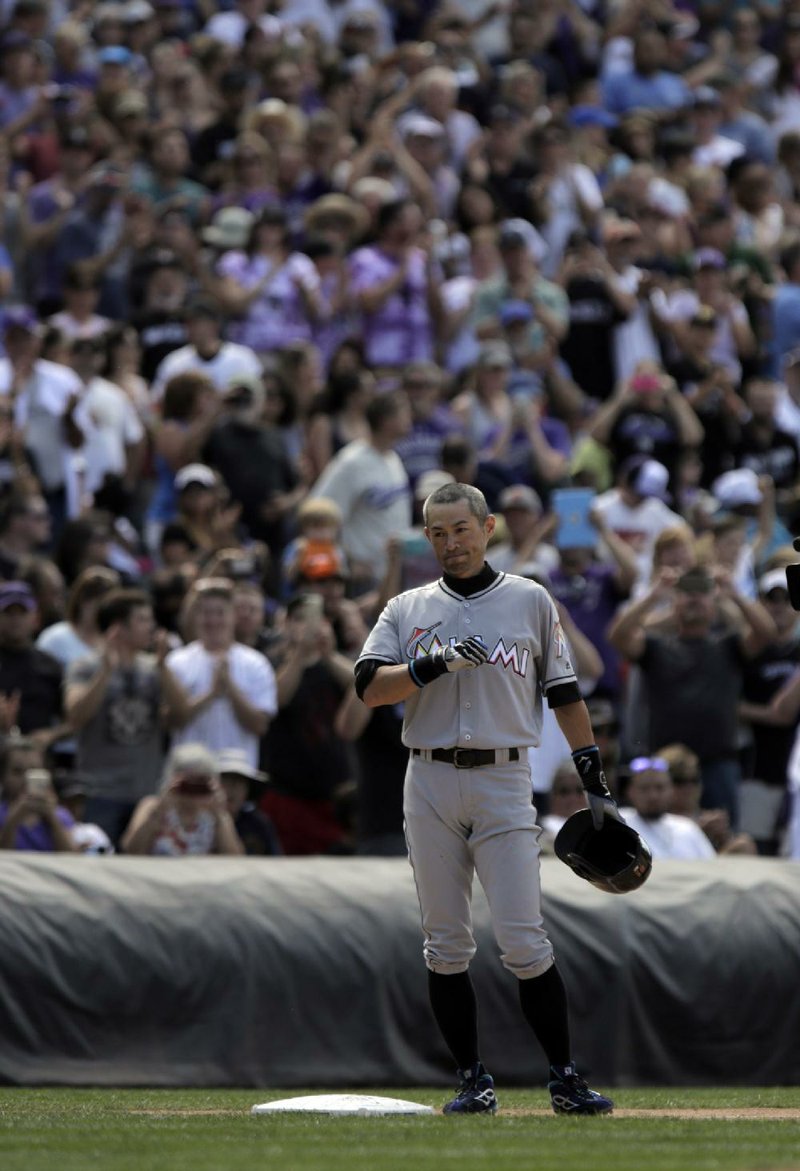 Miami outfielder Ichiro Suzuki acknowledges the crowd after his seventh-inning triple against Colorado on Sunday gave him 3,000 hits in his Major League Baseball career.