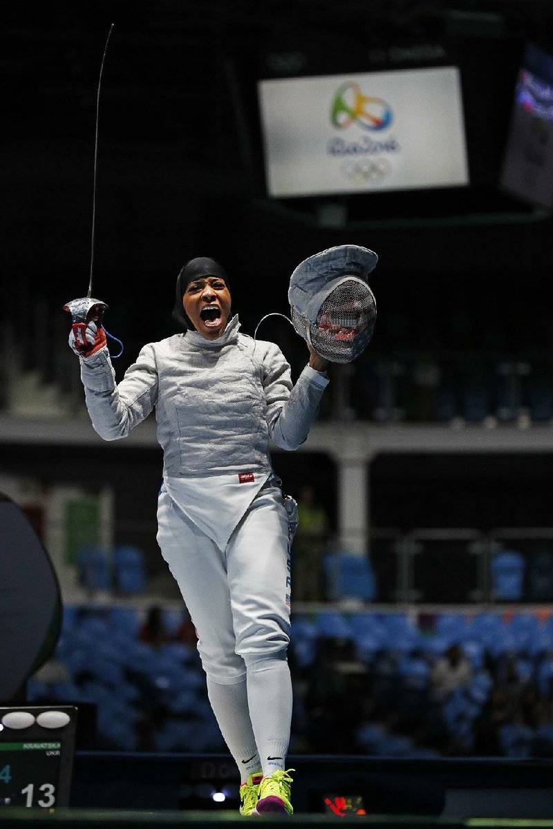 American fencer Ibtihaj Muhammad celebrates defeating Olena Kravatska, from Ukraine, during a women’s saber
individual match in Rio de Janeiro. Muhammad, 30, No. 8 in the world, lost in the round of 16 to France’s
Cecilia Berder.