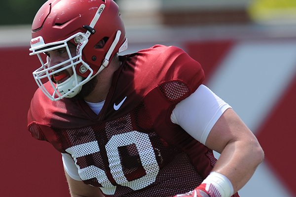 Arkansas offensive lineman Jake Raulerson participates in a drill during practice Saturday, Aug. 6, 2016, at the football practice field on the university campus in Fayetteville.