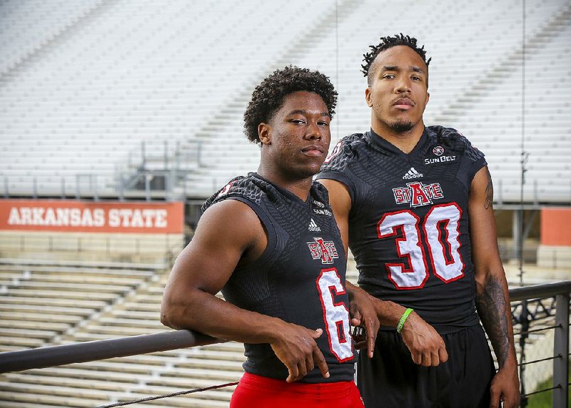 Running backs Warren Wand (left) and Johnston White are both fighting to become the Red Wolves’ primary runner this season.