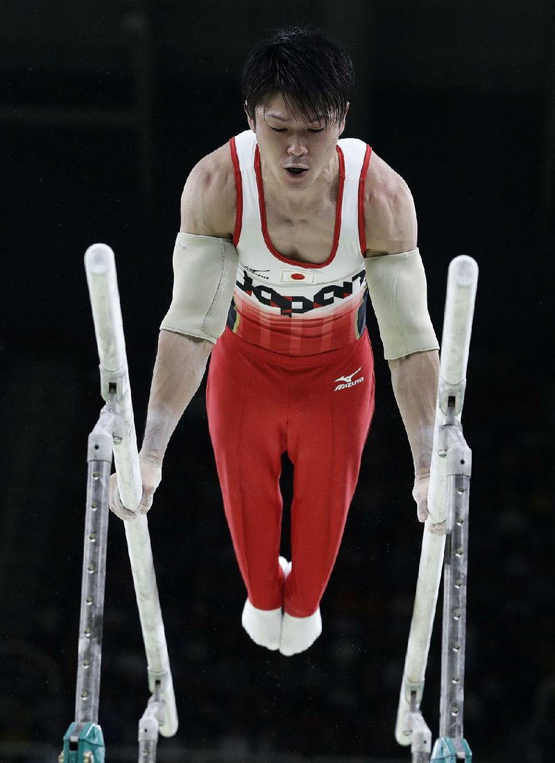 Japan’s Kohei Uchimura won the men’s gymnastics all-around by less than a tenth of a point Wednesday over Ukranian Oleg Verniaiev.