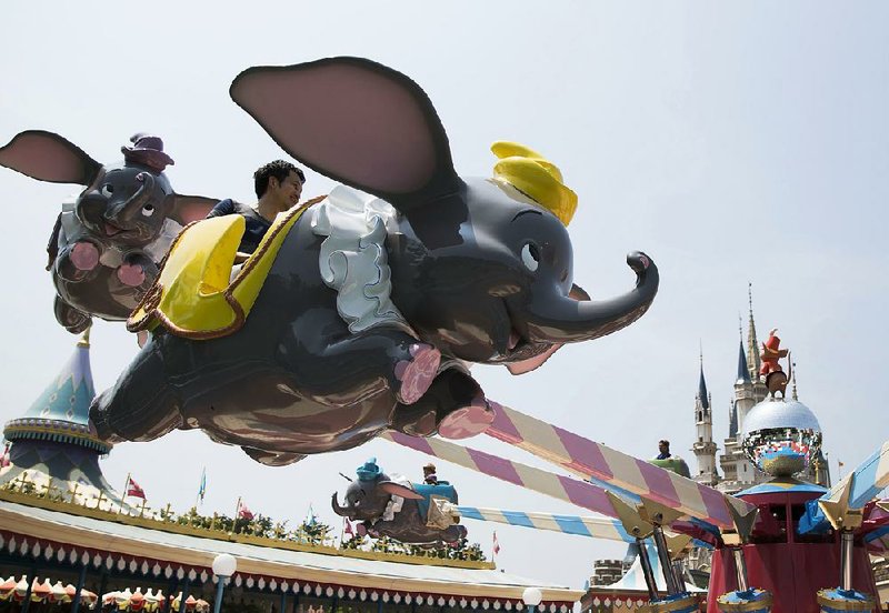 Visitors ride on the Dumbo The Flying Elephant ride at Tokyo Disneyland in July. Disney on Tuesday reported third-quarter sales of $14.3 billion. 