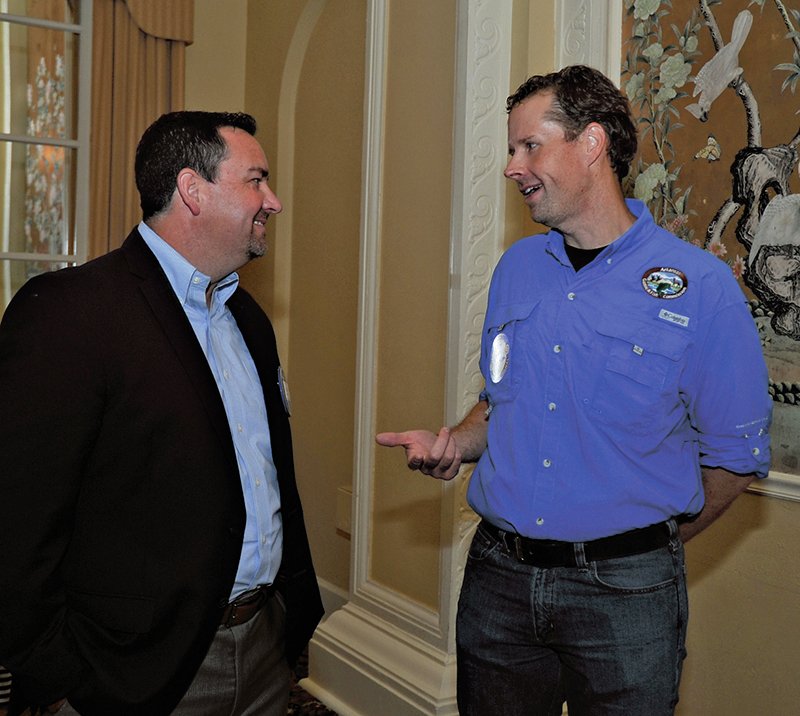 The Sentinel-Record/Mara Kuhn ROTARY MEETING: Hot Springs National Park Rotarian Jeff Weaver, left, speaks with Cory Gray, Arkansas Game and Fish Commission deer program coordinator, during the Rotary club's weekly meeting at the Arlington Resort Hotel & Spa on Wednesday.
