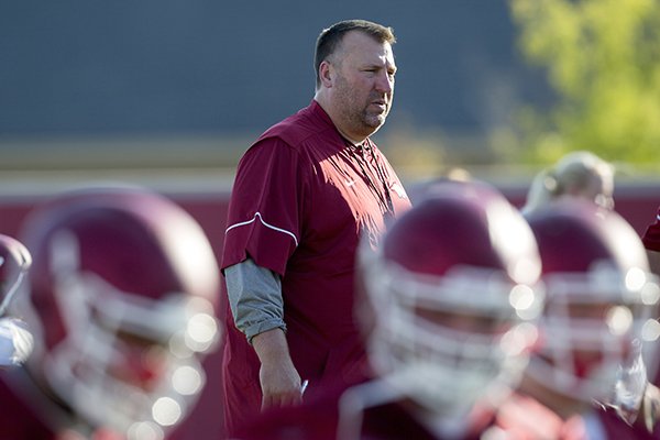 Arkansas coach Bret Bielema watches warmups prior to practice Thursday, Aug. 4, 2016, in Fayetteville. 
