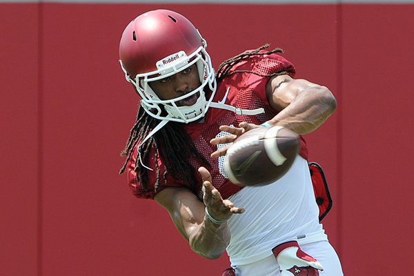 Arkansas receiver Keon Hatcher catches a pass during practice Thursday, Aug. 11, 2016, in Fayetteville. 