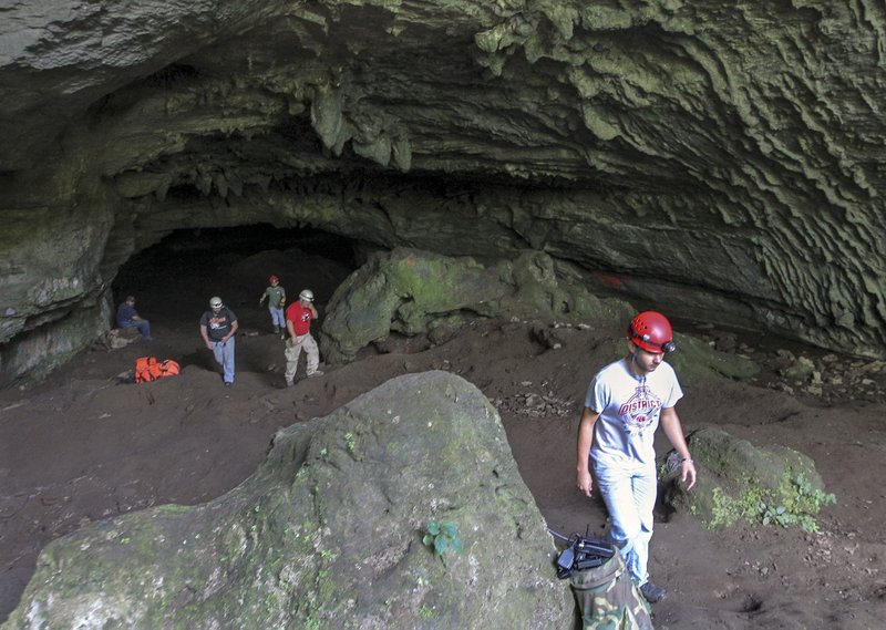 Firefighters from Izard and Independence counties exit the mouth of Blowing Cave in Cushman on Thursday afternoon after helping other search and rescue teams look for three missing ASU students who are believed to be in the cave. 