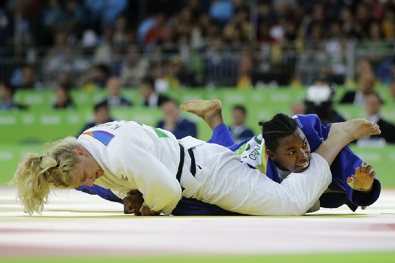 France’s Audrey Tcheumeo (right) taps out against American Kayla Harrison during the women’s 78-kg judo gold medal match Thursday in Rio de Janeiro. With just six seconds left, Harrison, who won the event in 2012 in London, caught Tcheumeo’s arm in an armlock, and forced the submission.