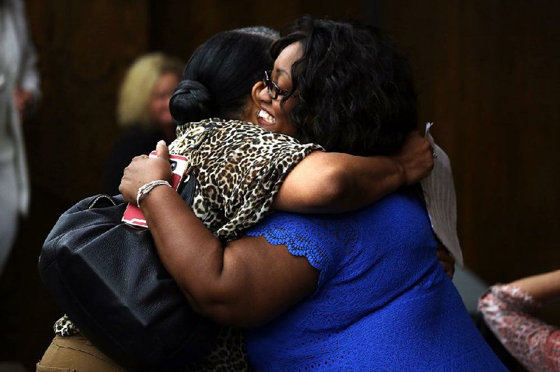 Jackie Breamsey (left) of Pine Bluff hugs Barbara Warren, superintendent of the Dollarway School District, after winning their appeal Thursday for Breamsey’s grandchild to change schools. 