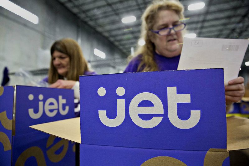 A worker double checks the contents of a customer order before sealing the package for shipment at the Jet.com Inc. fulfillment center in Kansas City, Kansas, last year. 
