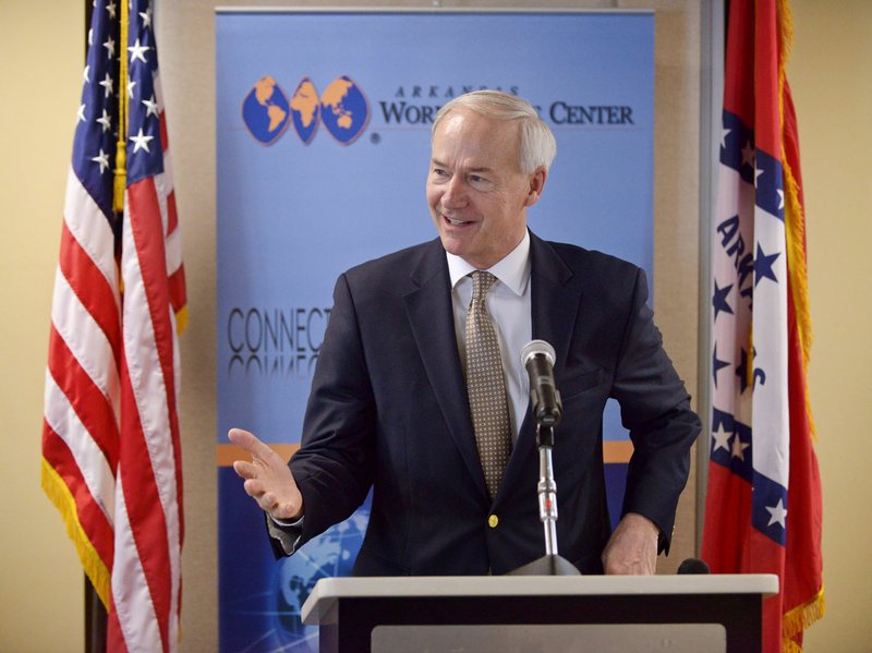 Gov. Asa Hutchinson speaks Friday during a grant announcement at the World Trade Center in Rogers. The U.S. Economic Development Administration announced three grants at the event, which will help pay for a new bridge in Benton County, the Fayetteville Chamber of Commerce Robotics Training Center and the promotion of trade for Arkansas companies through the trade center.