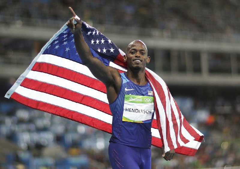 Former Sylvan Hills standout Jeff Henderson takes a victory lap after winning the gold medal in the men’s long jump Saturday night in the Rio Games. Henderson had a leap of 27 feet, 6 inches on his final jump to overtake South Africa’s Luvo Manyonga and win his first Olympic medal.