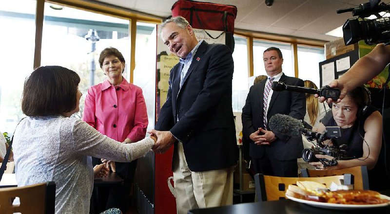 Democratic vice presidential candidate Tim Kaine greets a customer Saturday at the Bridge Cafe in Manchester, N.H., while campaigning with Sen. Jeanne Shaheen, D-N.H.