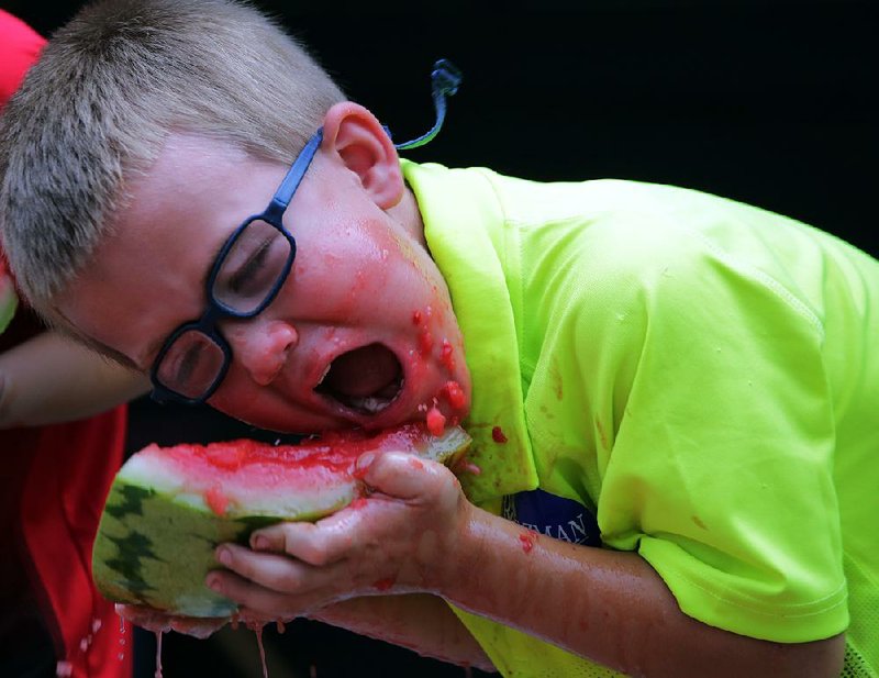 Timothy Landes, 5, of Hope digs in during a watermelon-eating contest at the 40th annual Hope Watermelon Festival on Saturday. More photos are available at arkansasonline.com/galleries. 