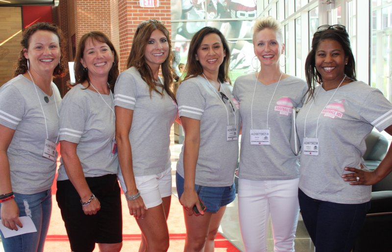 Amy Smith (from left), Jackie Segrest, Janelle Lunney, Jennifer Anderson, Karyn Smith and Angela Franks welcome Komen Ozark supporters to Football 101 on July 28 at the University of Arkansas Fred W. Smith Football
Center.