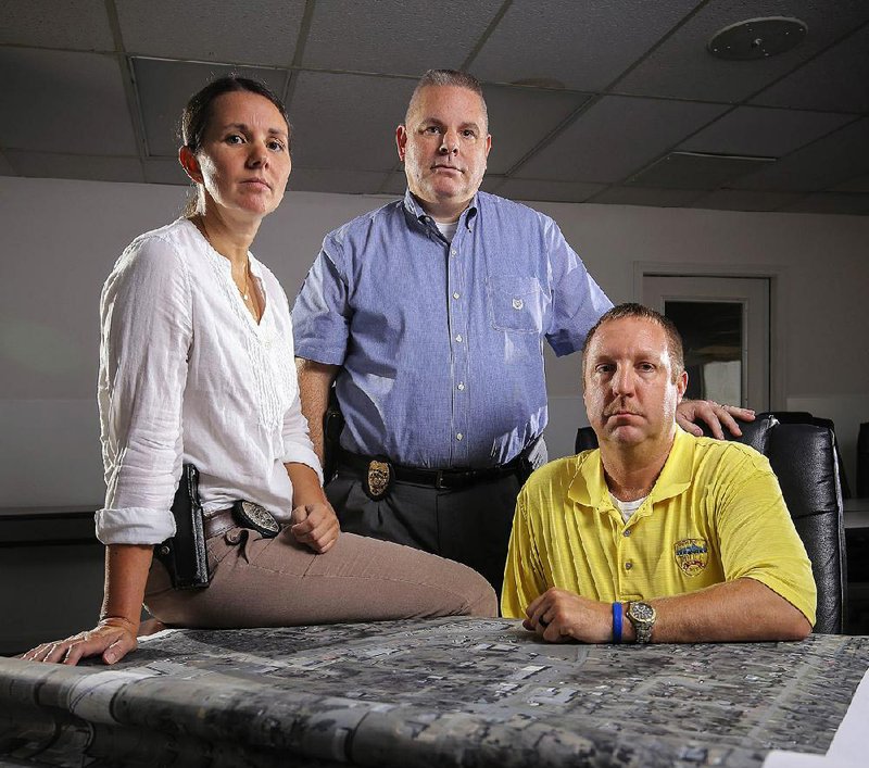 Police officers Terri Lee (from left), Steve Taylor and Brian Wyatt kept working on the case.