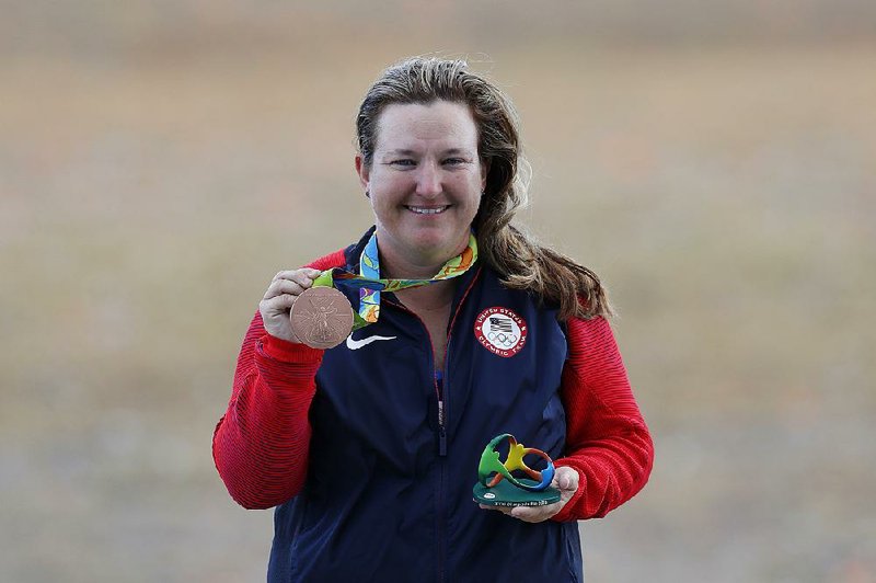 Kimberly Rhode of the United States shows off her bronze medal during the award ceremony for the women's 50 meter skeet event at Olympic Shooting Center at the 2016 Summer Olympics in Rio de Janeiro, Brazil, Friday, Aug. 12, 2016. 