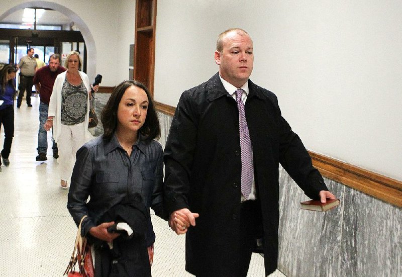 Judge Wade Naramore (right) walks into the Garland County Courthouse on Monday with his wife, Ashley. It took nearly 10 hours for attorneys to select a jury.