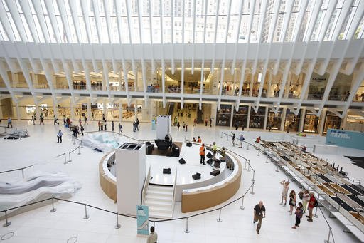 In this Monday, Aug. 15, 2016, photo, people walk through the World Trade Center Transportation Hub in New York. 