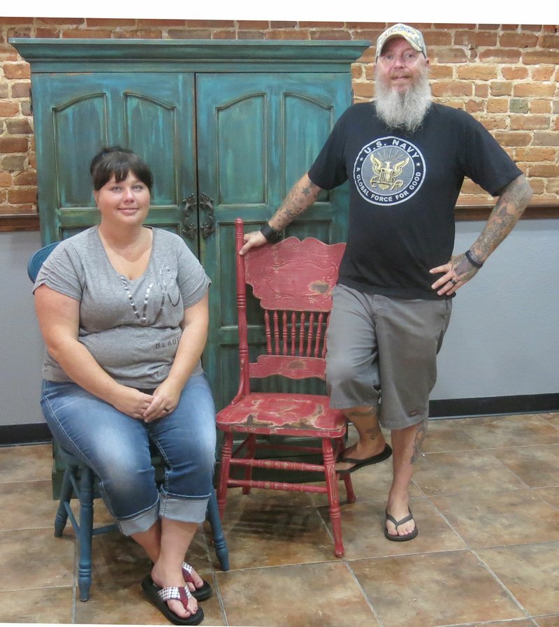 Photo by Susan Holland Les and Sylena Wingo will open their shop, The Junken Sailor, at 121 Main Street, S.E., in Gravette, on Saturday. They invite all to their open house Friday evening from 6 to 8 p.m. The shop features reclaimed furniture, rustic signs and home decor such as mirrors and candlesticks. The Junken Sailor will be open Tuesday through Friday from 10 a.m. to 6 p.m. with shorter hours on Saturday.