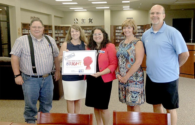 COURTESY PHOTO A representative with United Way of Northwest Arkansas, center, presents a $100,000 grant to Lincoln Consolidated School District staff Wes Newby, master teacher at the high school; Principal Courtney Jones, Jana Claybrook, district curriculum coordinator; and Deon Birkes, assistant principal.