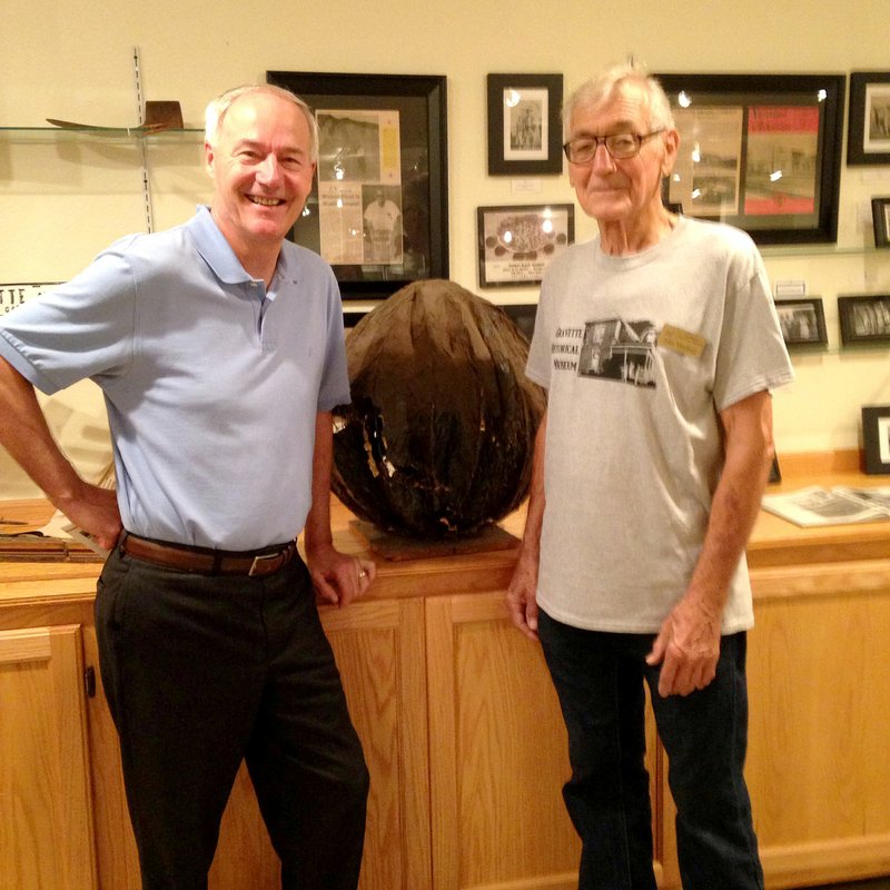 Photo by Erin McVittie Governor Asa Hutchinson returned to Gravette to attend the annual Gravette Day activities. This year&#8217;s theme was &quot;Just a kid from Gravette&quot; and the celebration honored Hutchinson and many other folks from Gravette who have become successful in various fields. Here he is seen visiting with John Mitchael in the Gravette historical museum annex. Behind them is a display of memorabilia from the Gravette shelling plant.