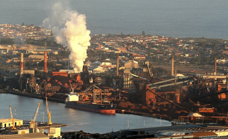 In this July 2, 2014 file photo, smoke billows out of a chimney stack of BHP steelwork factories at Port Kembla, south of Sydney, Australia. 