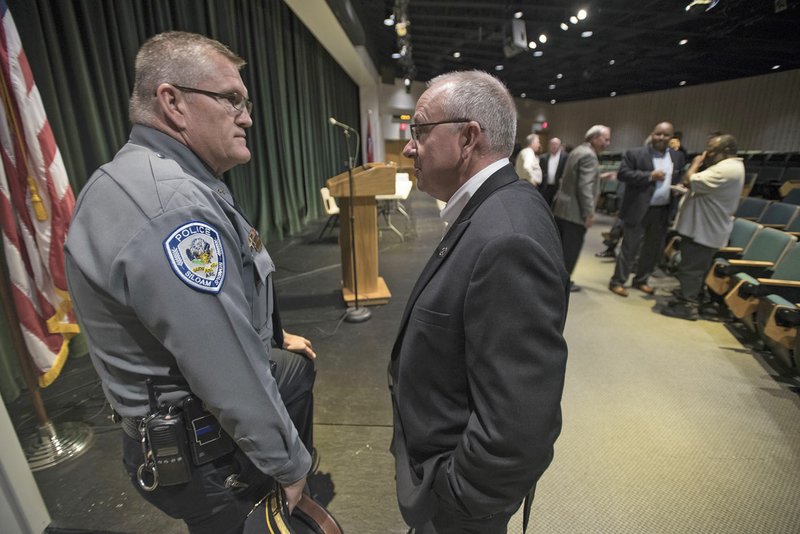 Jim Wilmeth, (left), Siloam Springs police chief, visits Tuesday with Sheriff Meyer Gilbert of Benton County before a forum at Northwest Arkansas Community College in Bentonville. Law enforcement leaders participated in the forum to give the public a chance to weigh in on police procedures.