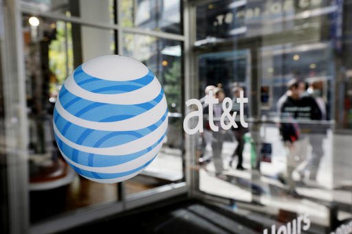 This Oct. 17, 2012, file photo shows an AT&T logo on an AT&T Wireless retail store front in Philadelphia.
