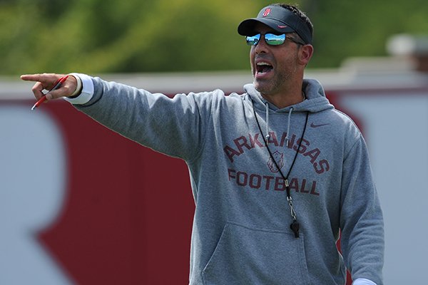 Dan Enos, Arkansas offensive coordinator and quarterbacks coach, directs his players during practice Saturday, Aug. 6, 2016, at the football practice field on the university campus in Fayetteville. 