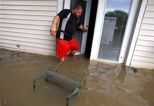 Wade Gary exits his home after viewing the damage in his studio apartment from floodwater Tuesday, Aug. 16, 2016, in Abbeville, La. 