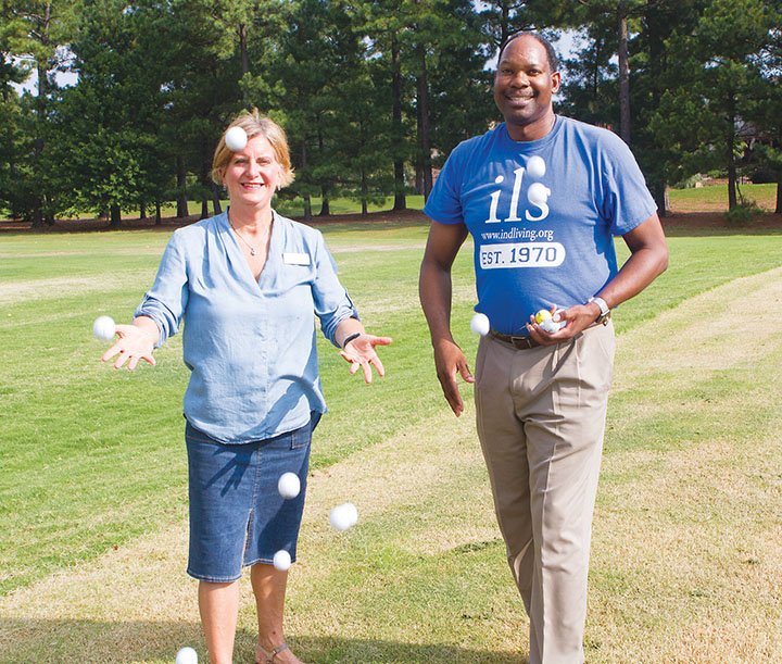 Elissa Douglas, executive director of Independent Living Services in Conway, and Robert Wright, director of development for the nonprofit agency, throw golf balls into the air on the driving range at Centennial Valley Country Club in Conway. The 11th annual ILS Golf Ball Drop is scheduled for 5:30-7 p.m. Sept. 1. 
It will include a grand prize of $2,016, as well as free hamburgers, hot dogs, drinks and ice cream, and a bounce house for kids.