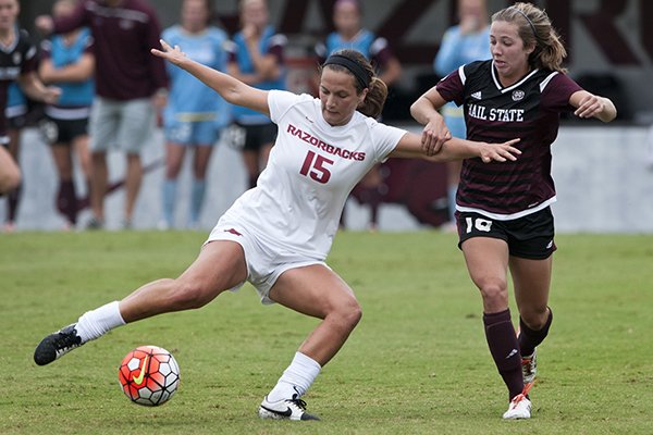 Jessi Hartzler (15) of Arkansas attempts a shot on goal under pressure from Mississippi State's Courtney Robicheaux in the first half on Sunday Sept. 20, 2015, during the match at Razorback Field in Fayetteville.