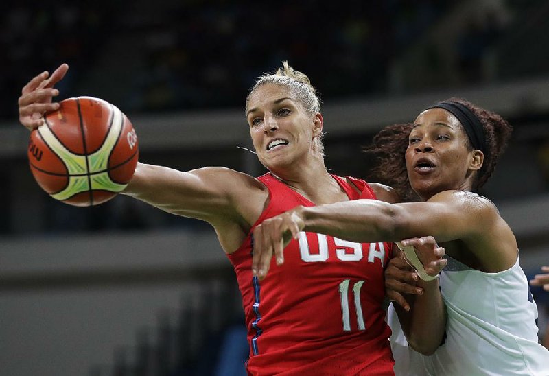 United States forward Elena Della Donne (left) battles for a rebound with France center Marielle Amant during the women’s basketball semifinals Thursday. The Americans pulled away to beat France 86-67 and advanced to Saturday’s gold-medal game against Spain.