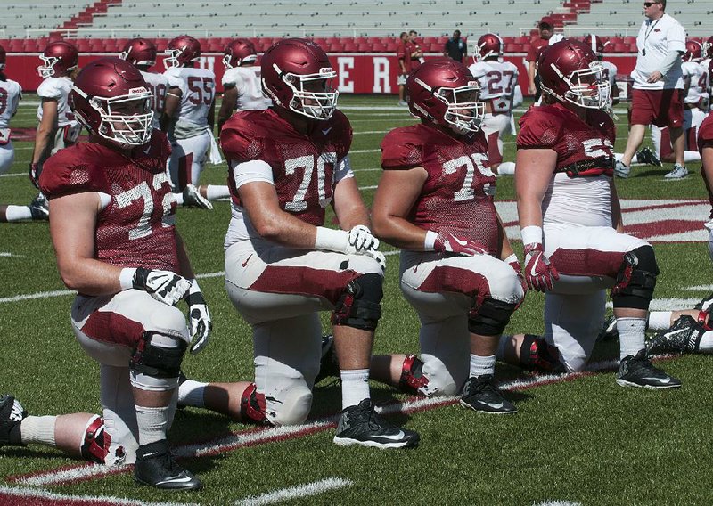 NWA Democrat-Gazette/MICHAEL WOODS • @NWAMICHAELW
University of Arkansas linemen Frank Ragnow (72), Dan Skipper (70) Zach Rogers, (75) and Hjalte Froholdt (51) stretch out during practice Saturday, August 13, 2016 at Razorback Stadium in Fayetteville.