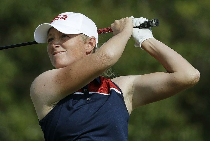 Former Arkansas Razorback Stacy Lewis tees off on the 4th hole during the second round of the women’s golf tournament Thursday in Rio de Janeiro. Lewis made 11 birdies to match the low score at Olympic Golf Course and is one stroke behind South Korea’s Inbee Park.