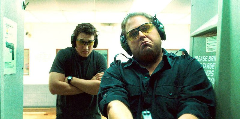 Would-be arms dealers David (Miles Teller) and Efraim (Jonah Hill) sample the merchandise in the fact-based dark comedy War Dogs.