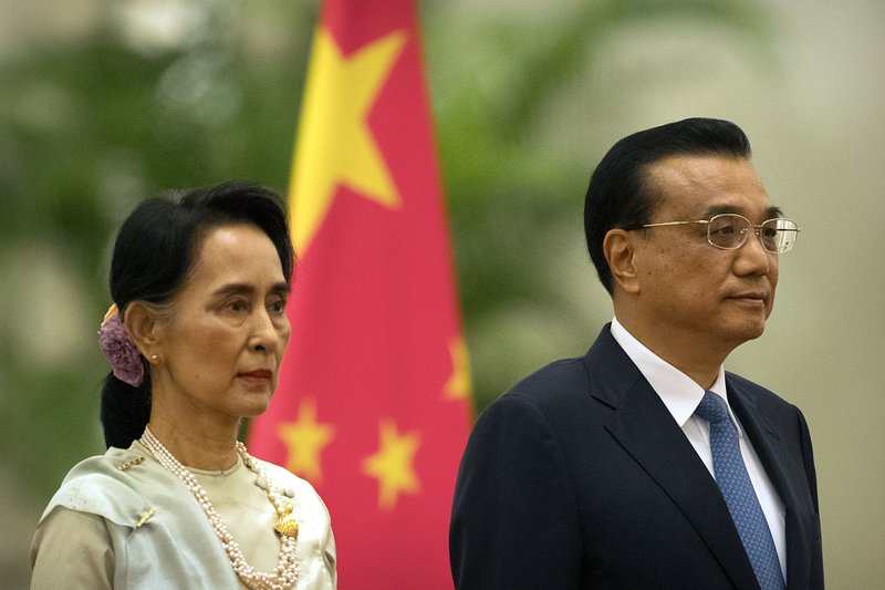 Myanmar's State Counselor Aung San Suu Kyi, left, and China's Premier Li Keqiang, right, stand during a welcome ceremony at the Great Hall of the People in Beijing, Thursday, Aug. 18, 2016. 