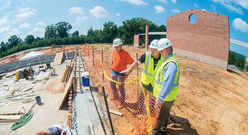 Jerry Short, job-site supervisor, from left, Stanley Hunt, project manager, and Mayor Randy Horton stand at the site of the $6.6 million Russellville Aquatic Center under construction on Phoenix Avenue. The project has been talked about for three years, Horton said. It will include a competition/recreation pool and a therapy pool, “inflatable pool amenities” and a splash pad for children, as well as meeting/party rooms. The facility is scheduled to be completed in early summer 2017, Horton said.