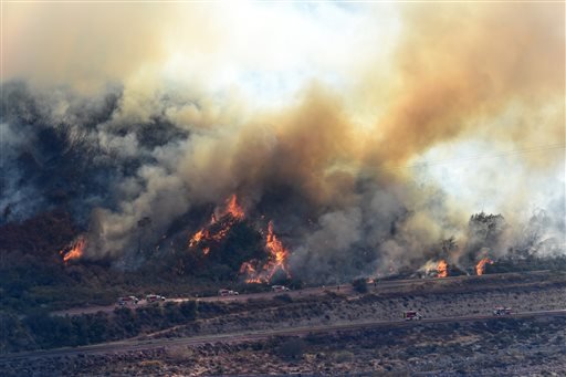 A wildfire flares up near Cajon Boulevard in Devore, Calif., on Thursday, Aug. 18, 2016.

