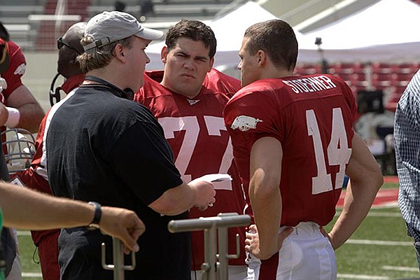 Director David Hunt, left, speaks with actors Chris Severio, center, and Connor Antico during filming for the movie "Greater" on Wednesday, May 29, 2013, at Razorback Stadium in Fayetteville. 