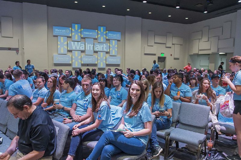 Wal-Mart interns gather in an auditorium for an informational session. Wal-Mart typically offers jobs to at least 75 percent of its interns.