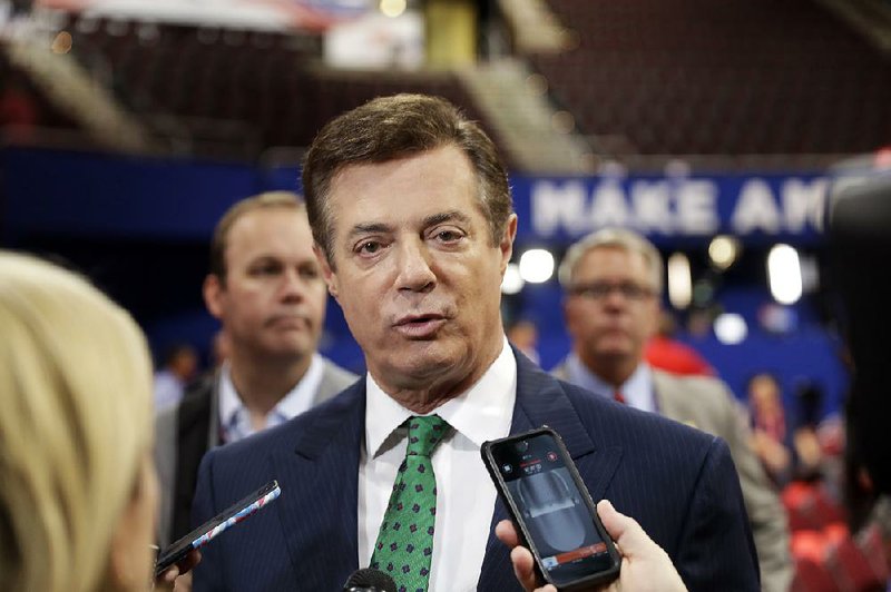 In this July 17, 2016 file photo, Trump Campaign Chairman Paul Manafort talks to reporters on the floor of the Republican National Convention at Quicken Loans Arena, Sunday, in Cleveland.  