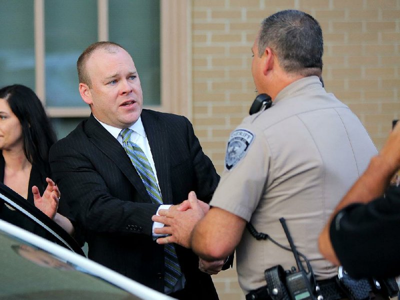 Judge Wade Naramore (left) thanks a deputy as he leaves the Garland County Courthouse in Hot Springs after Naramore was found innocent in August in the hot-car death of his son. 